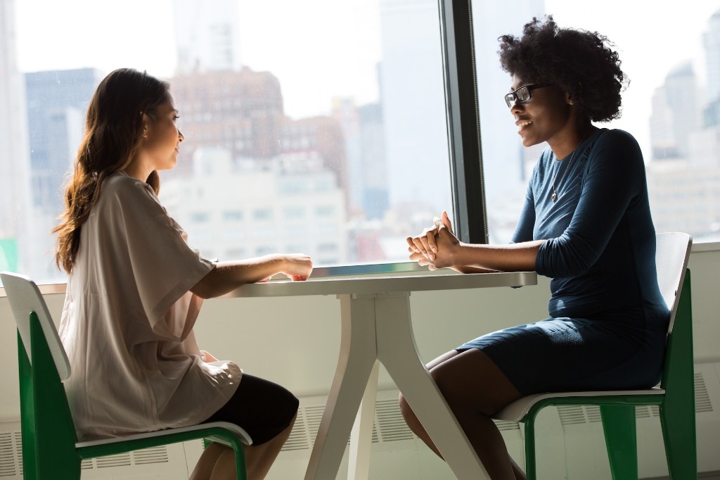 Two people talking during an in-person clinic consultation