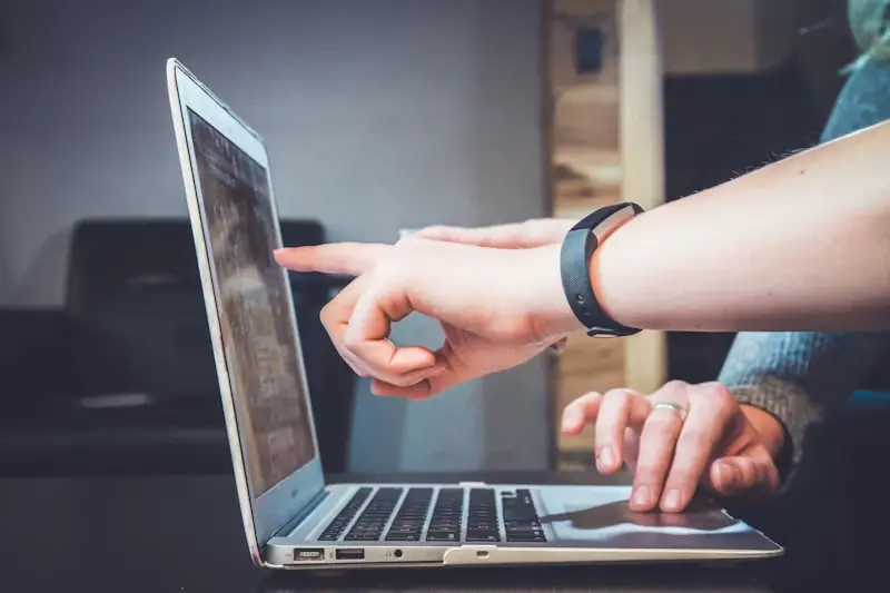 Two people reviewing information together on a laptop