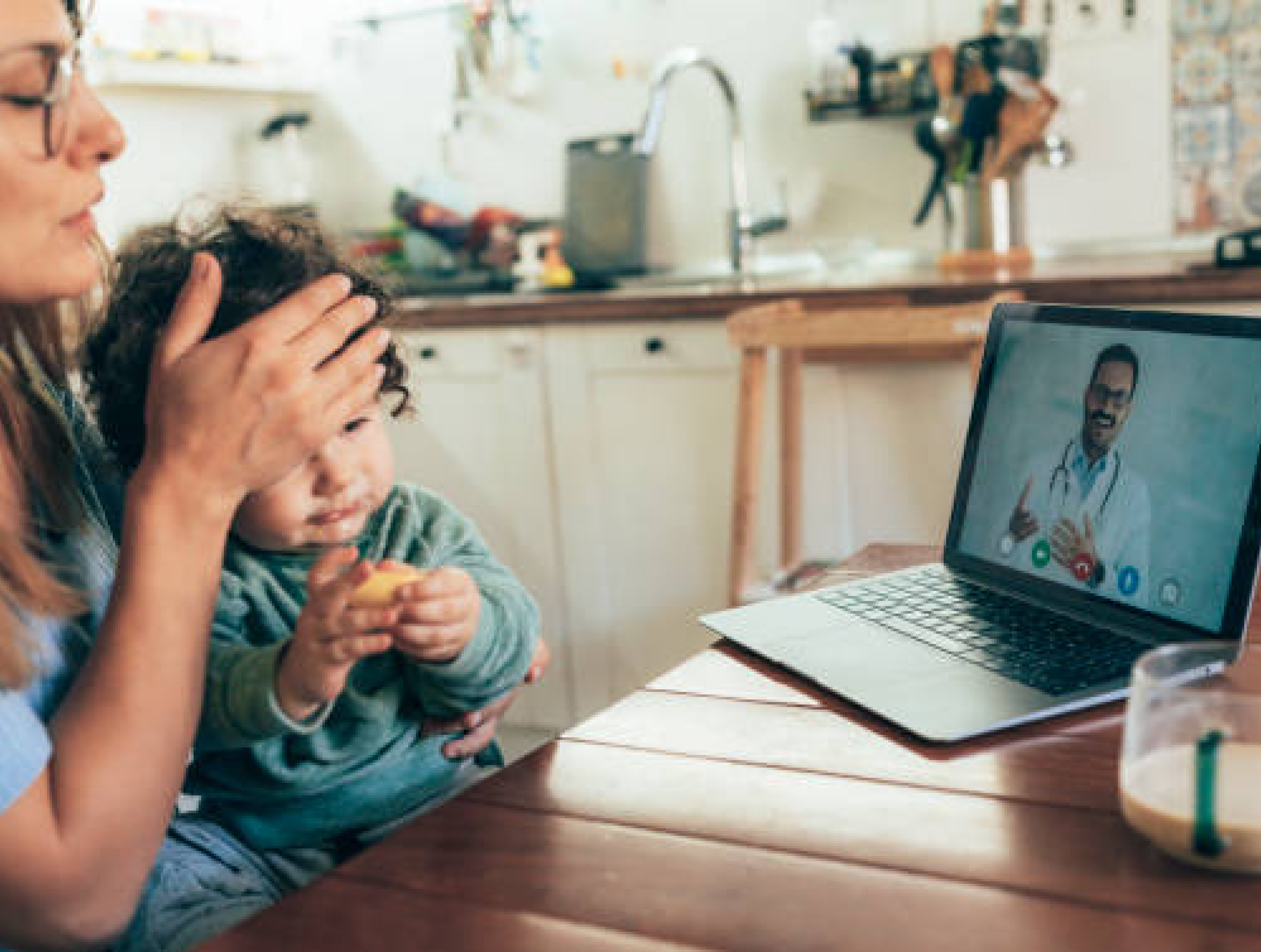 A parent and young child attending a paediatric telehealth appointment from home